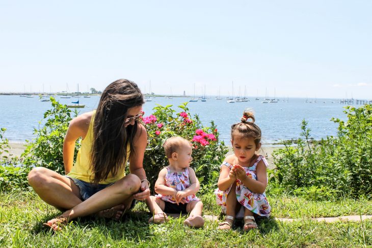 Woman sitting with baby and girl on Connecticut Coast