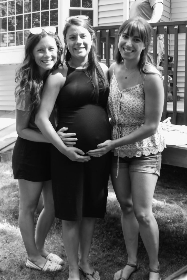 Sisters Holding their Sister's pregnant belly