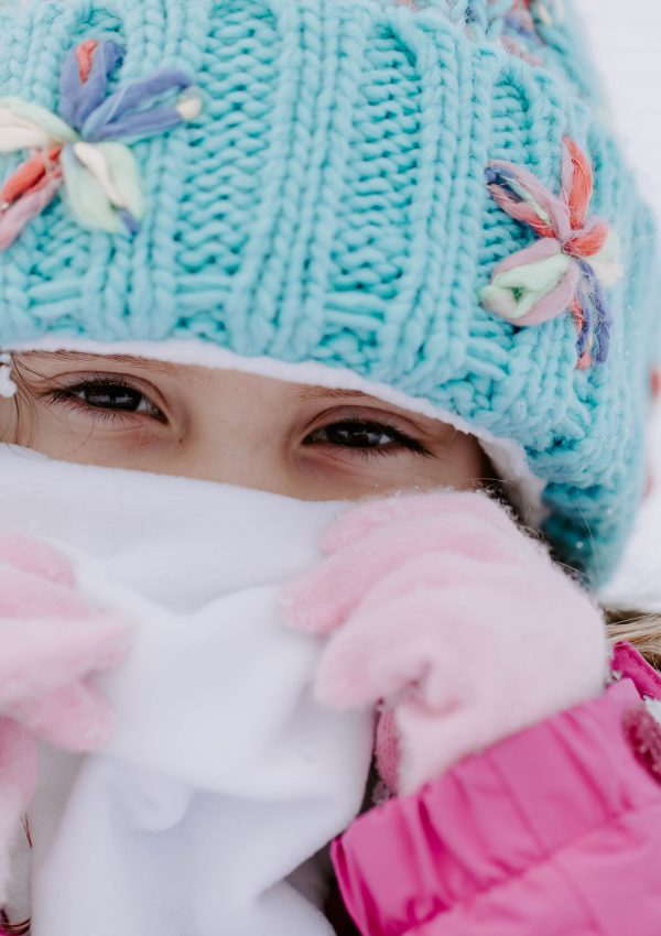 Little Girl Wearing Blue Winter Hat Pink Gloves and White Face Neck Wrap