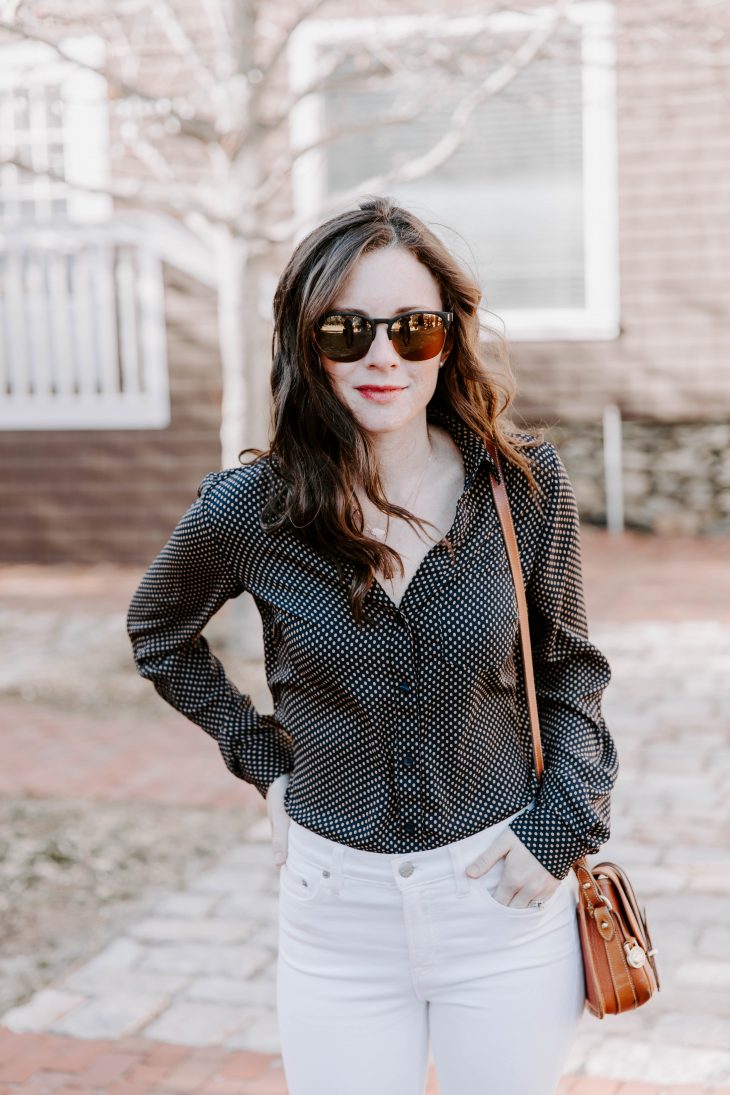 A Mommy blogger wearing a polka dot blouse