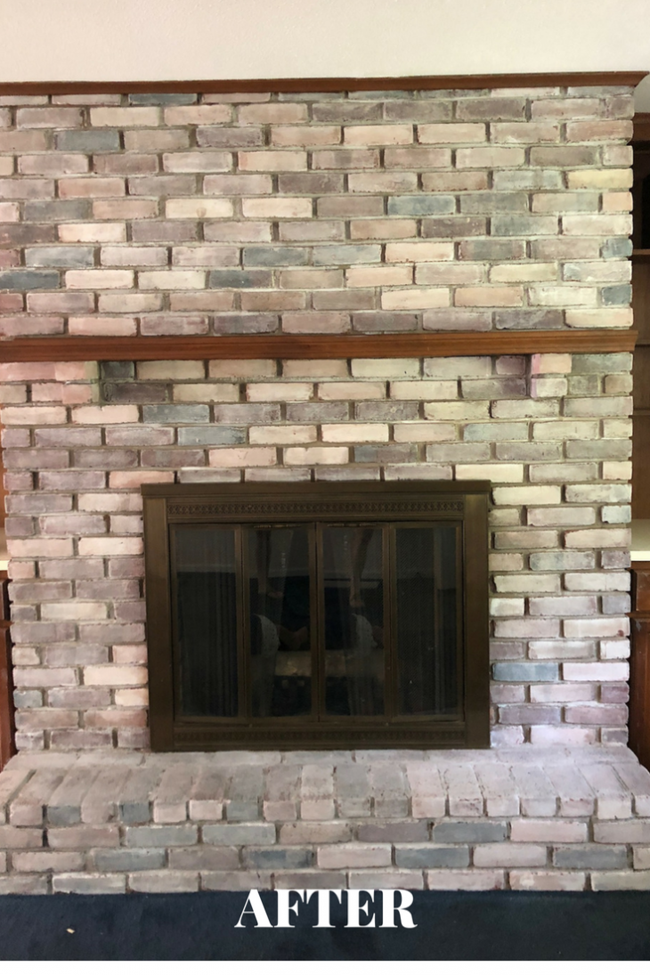whitewash fireplace with brown wood molding