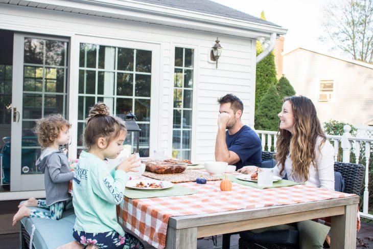 Family eating dinner together outside on deck