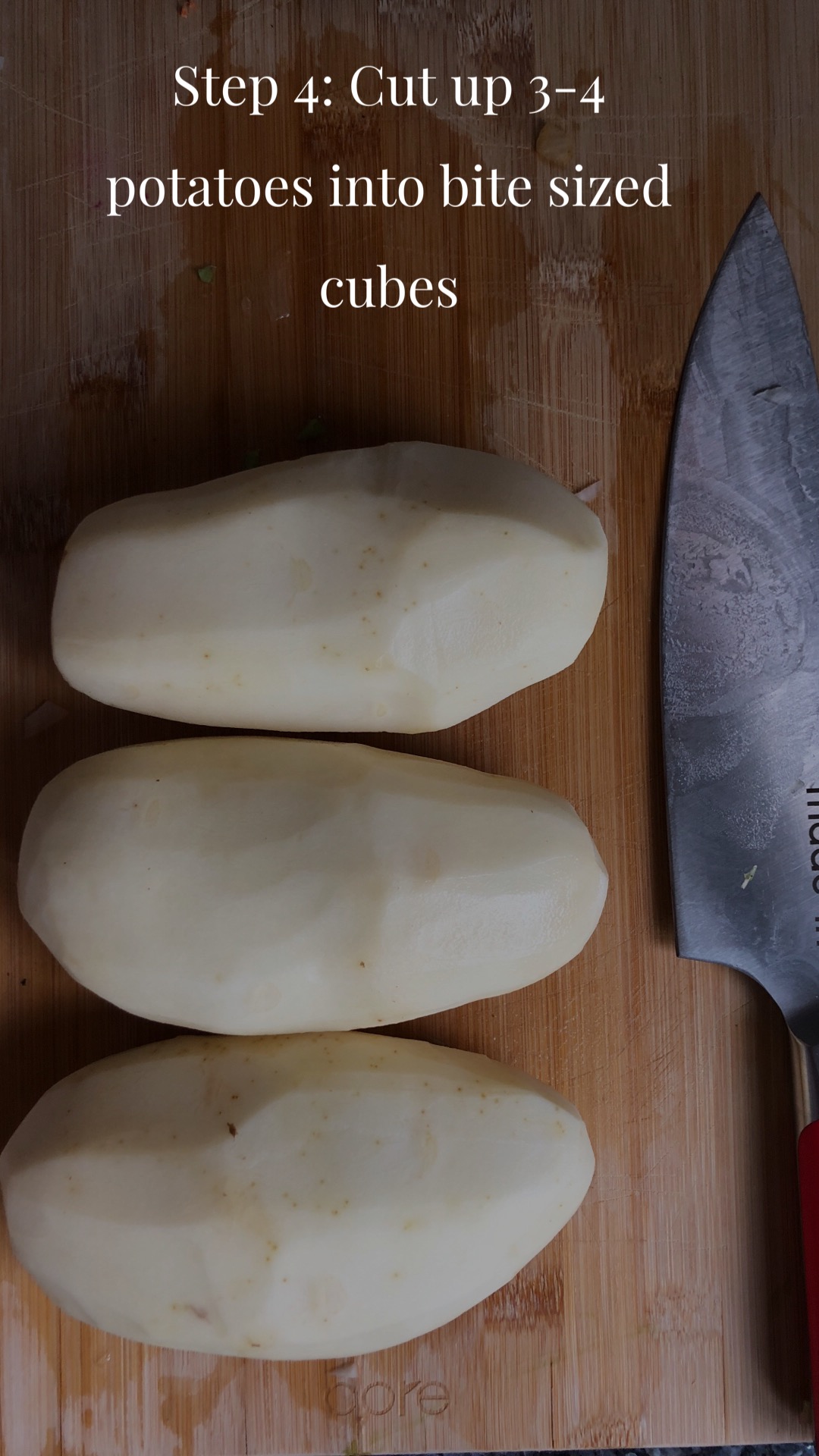 Three potatoes lined next to a knife
