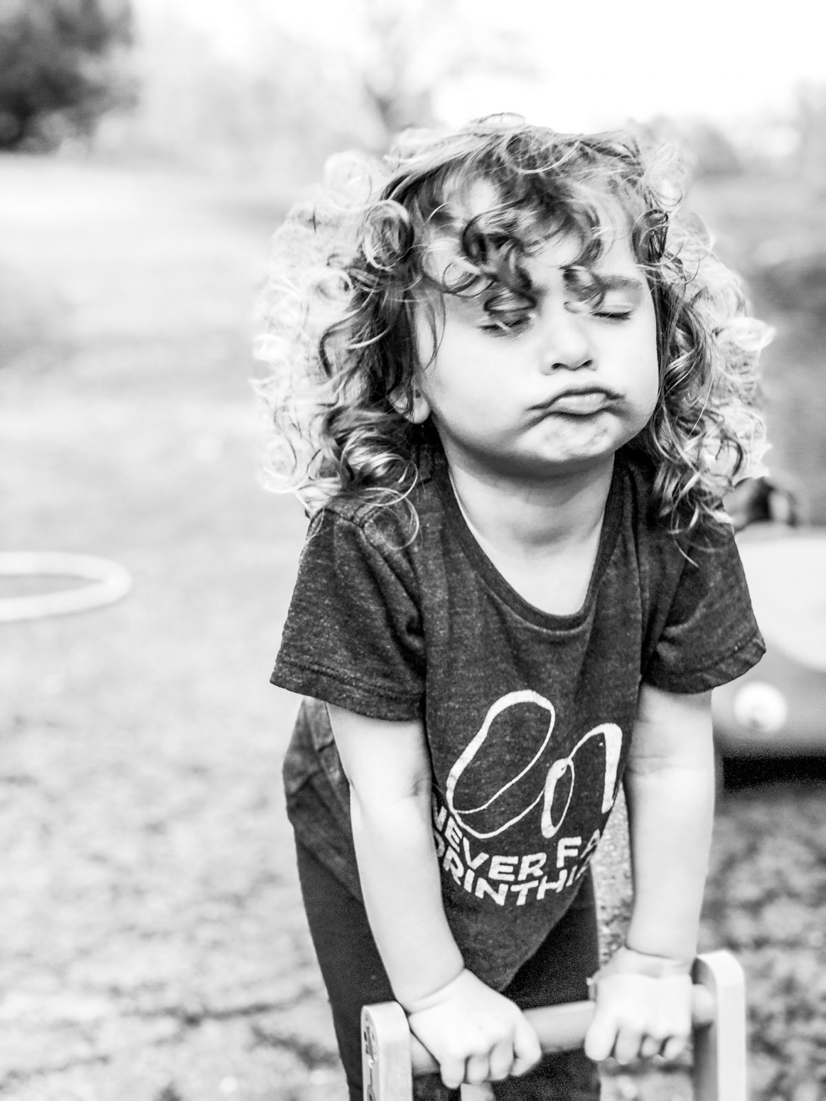 curly haired little girl making a pouty face