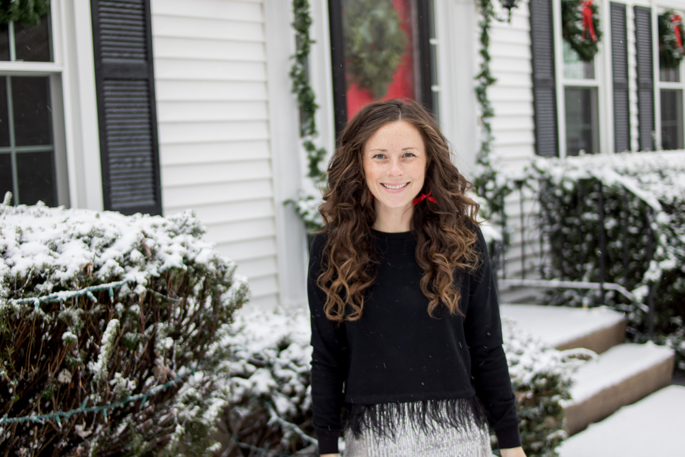 woman wearing black top smiling outside in snow botox
