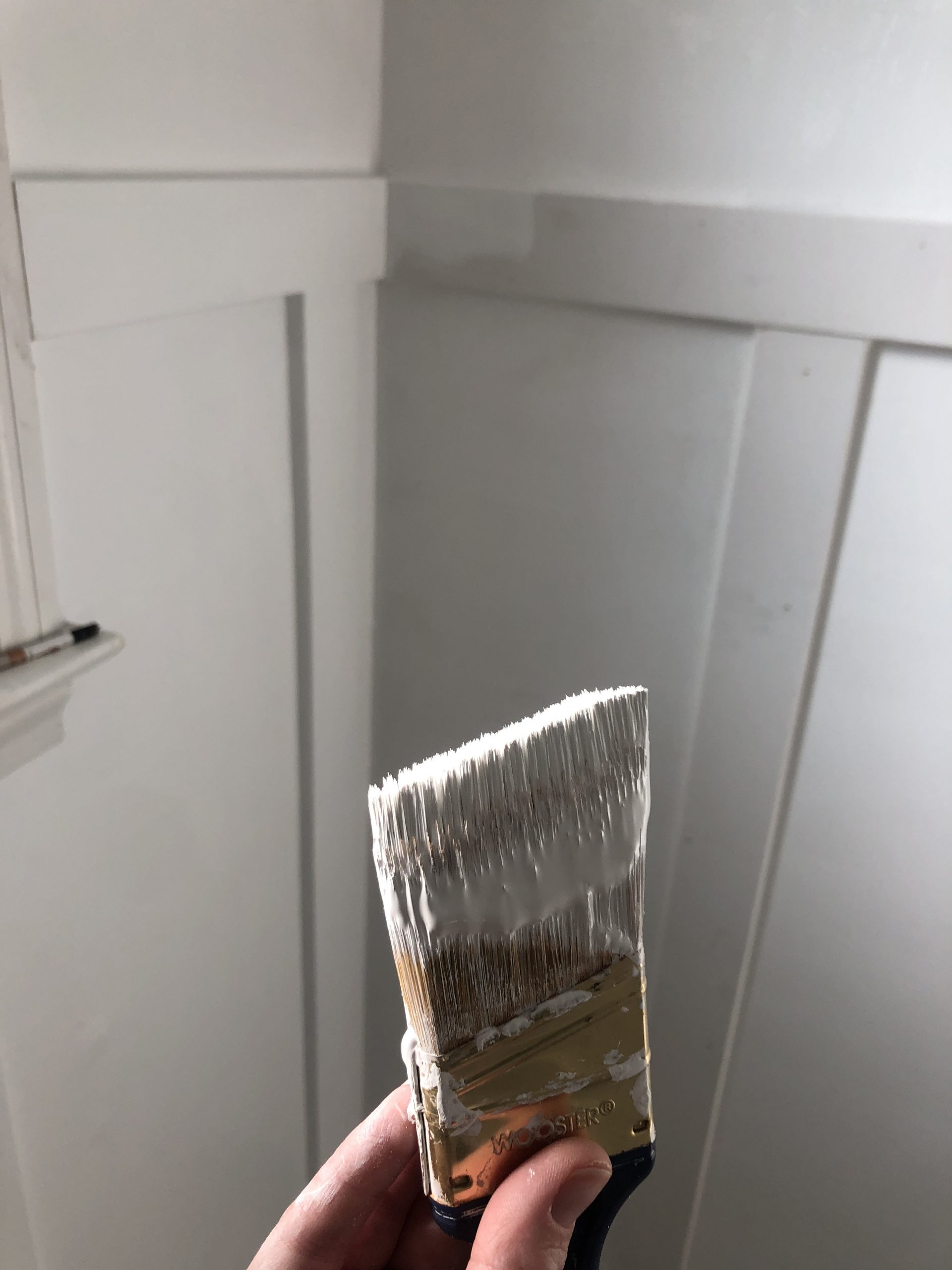 board and batten walls with white paint brush