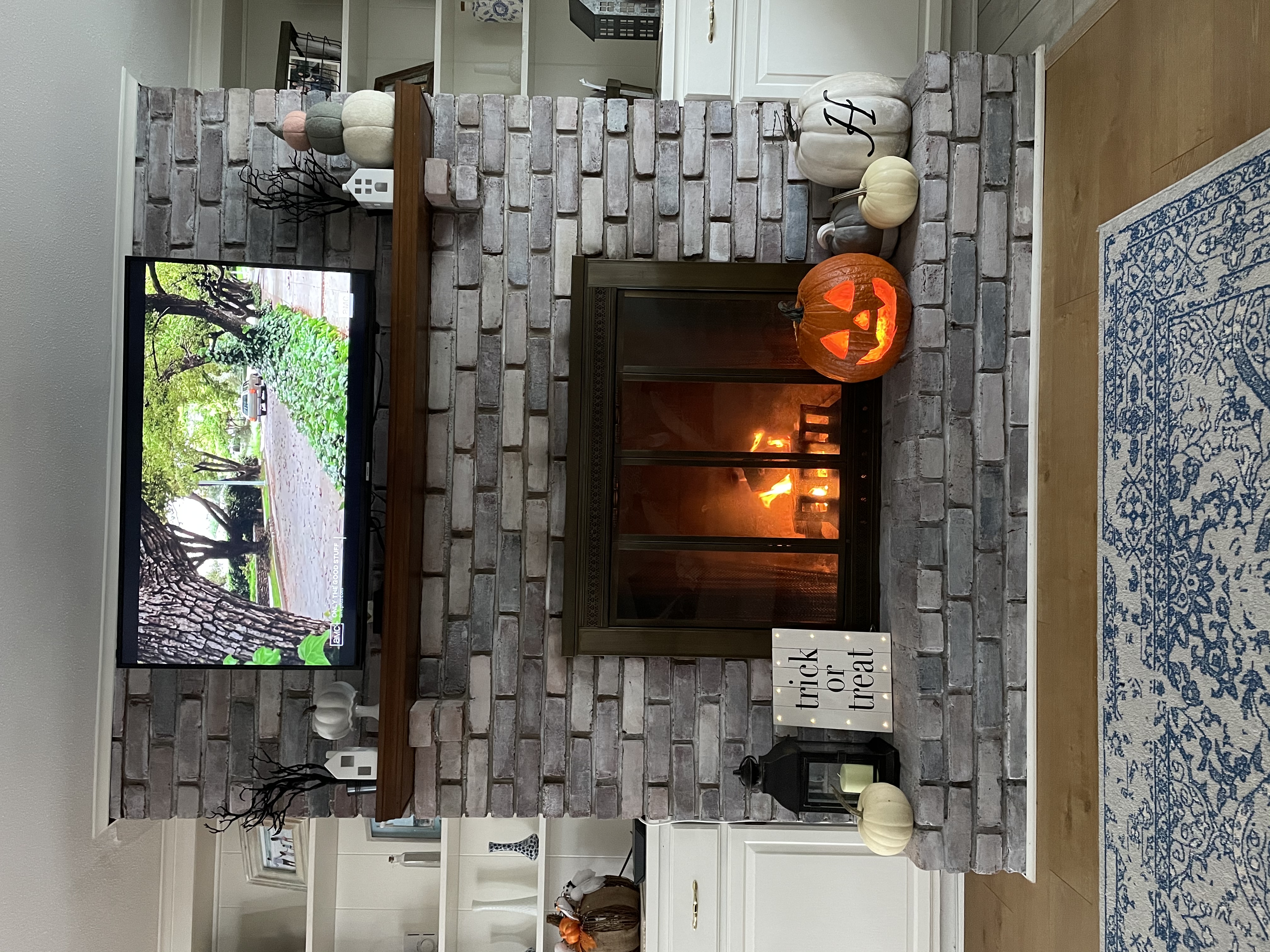 Halloween mixed with Fall Mantle whitewash fireplace and Halloween on TV