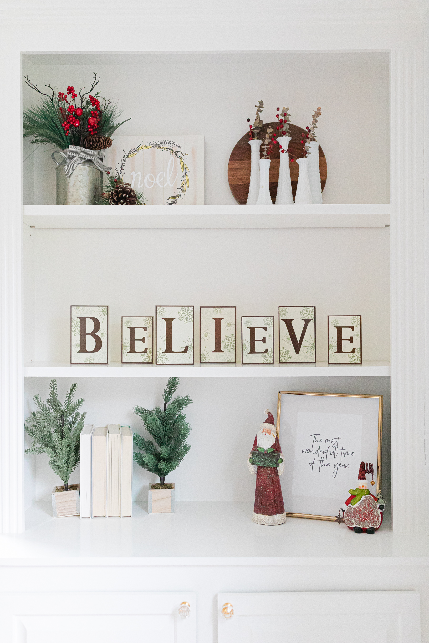 white built in shelving decorated for Christmas