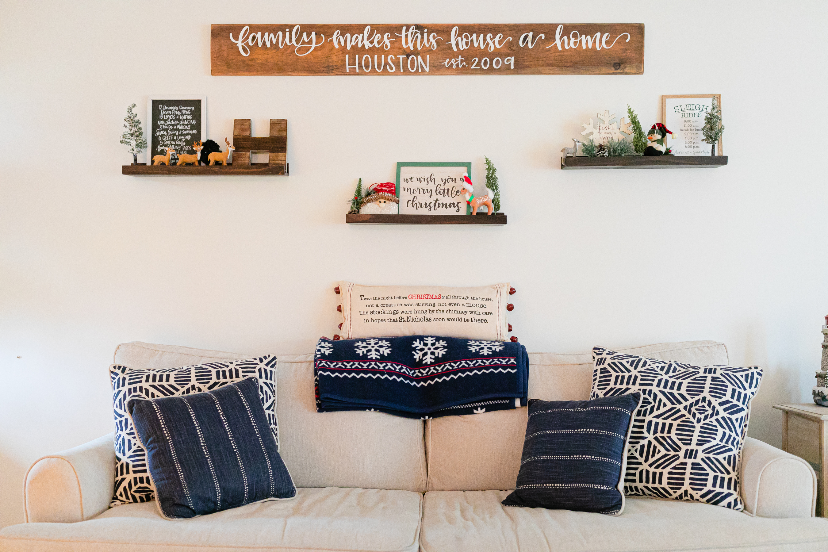 holiday decor on floating shelves above couch