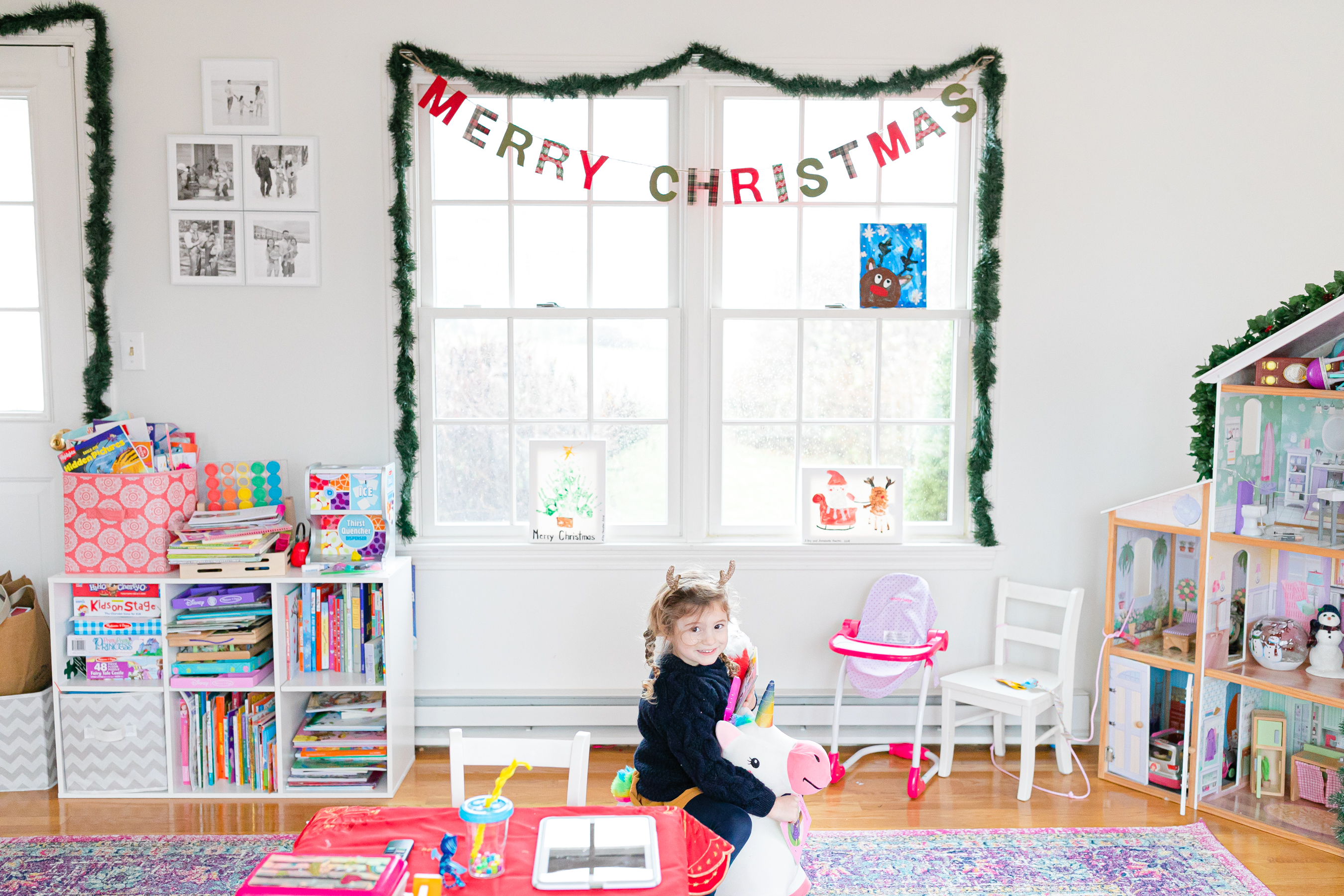 little girl in playroom decorated for Christmas