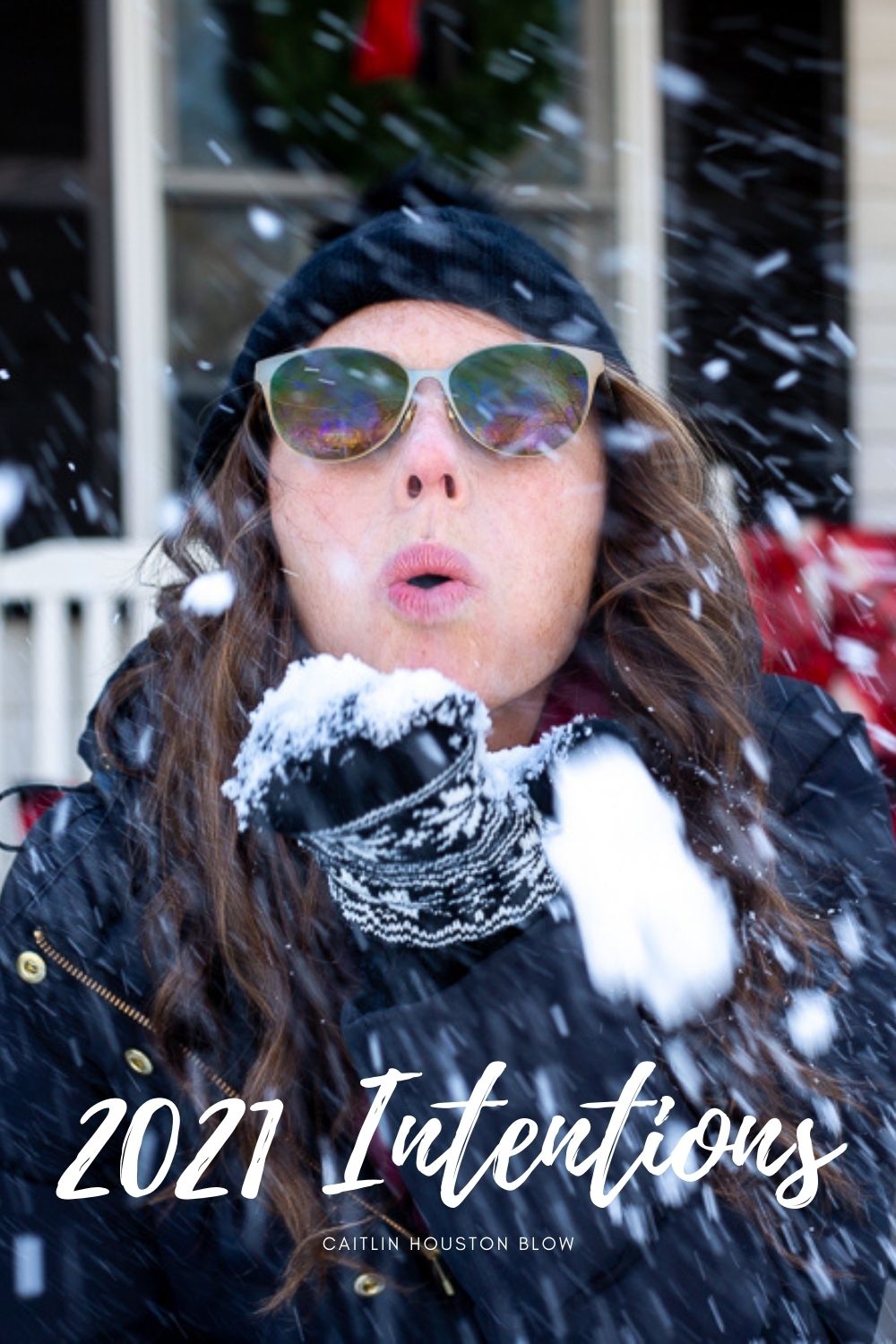 woman blowing snow at camera setting 2021 intentions