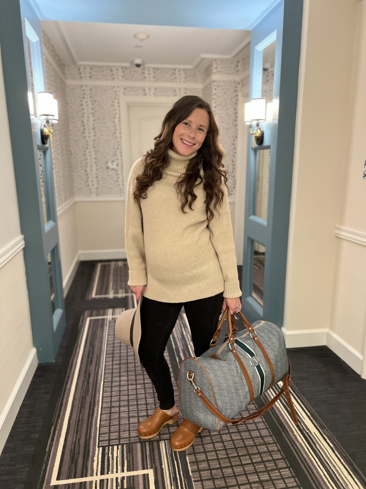 pregnant woman with travel bag at Delamar West Hartford