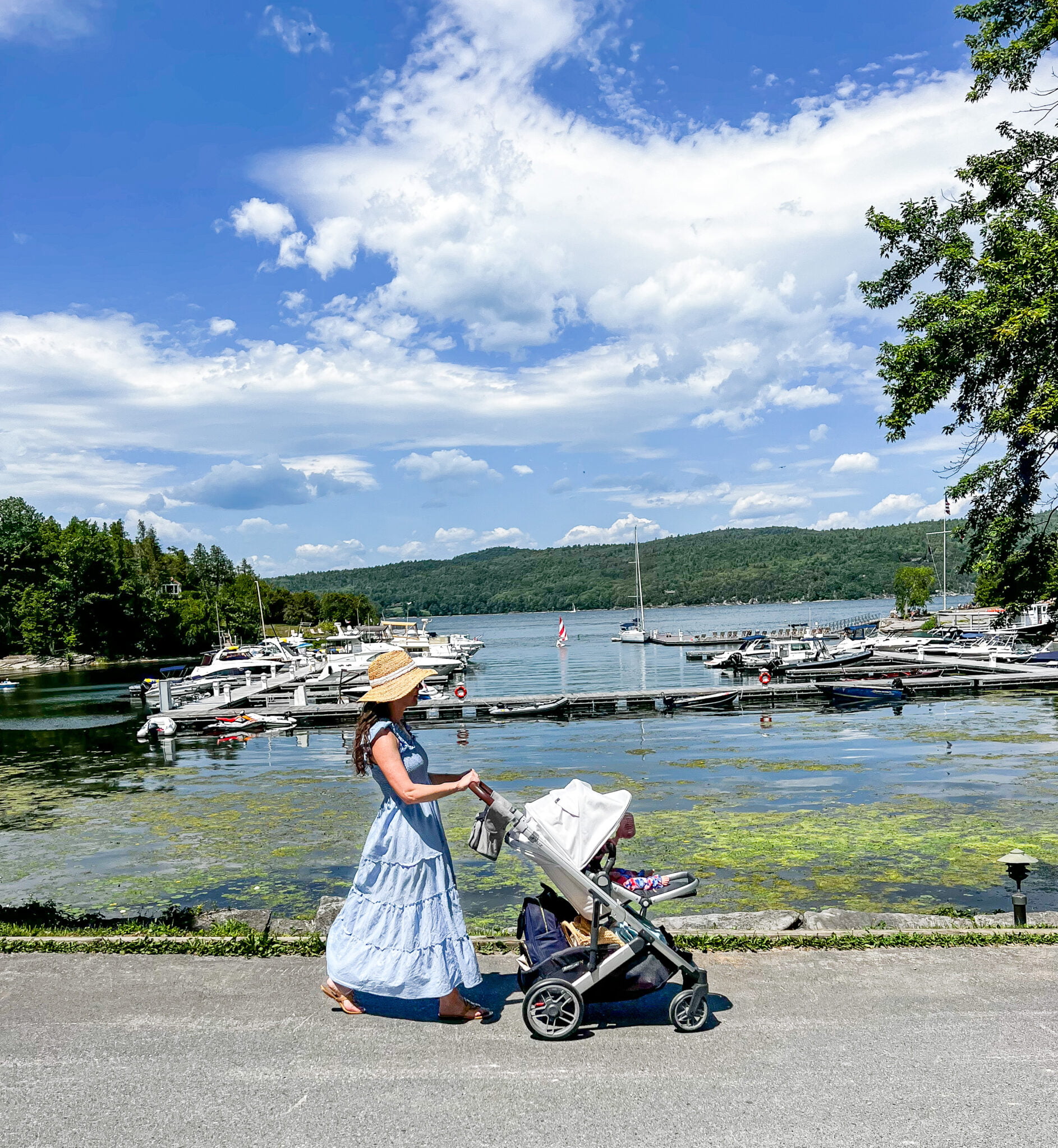 Mom walking baby at Basin Harbor by Lake in stroller