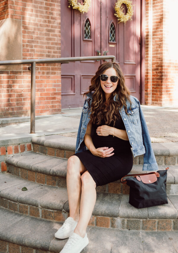 Tips for Surviving Your First Period After Pregnancy Pregnant Woman in Black Dress sitting on church steps