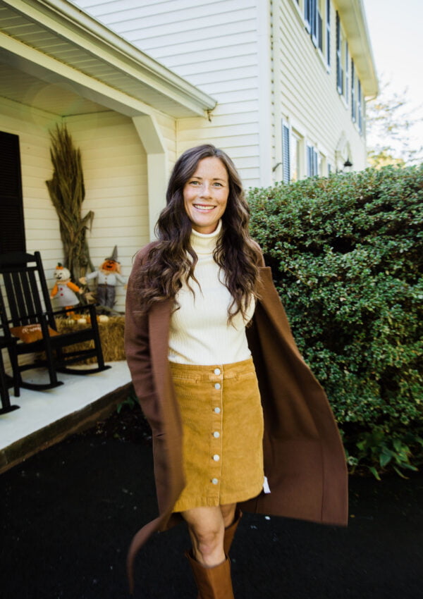 brown sweater cardigan with turtleneck corduroy skirt and riding boots