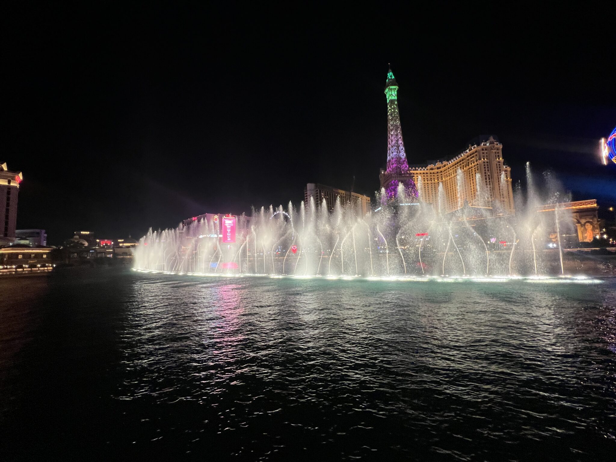 The fountains at the Bellagio at Night with Paris in background