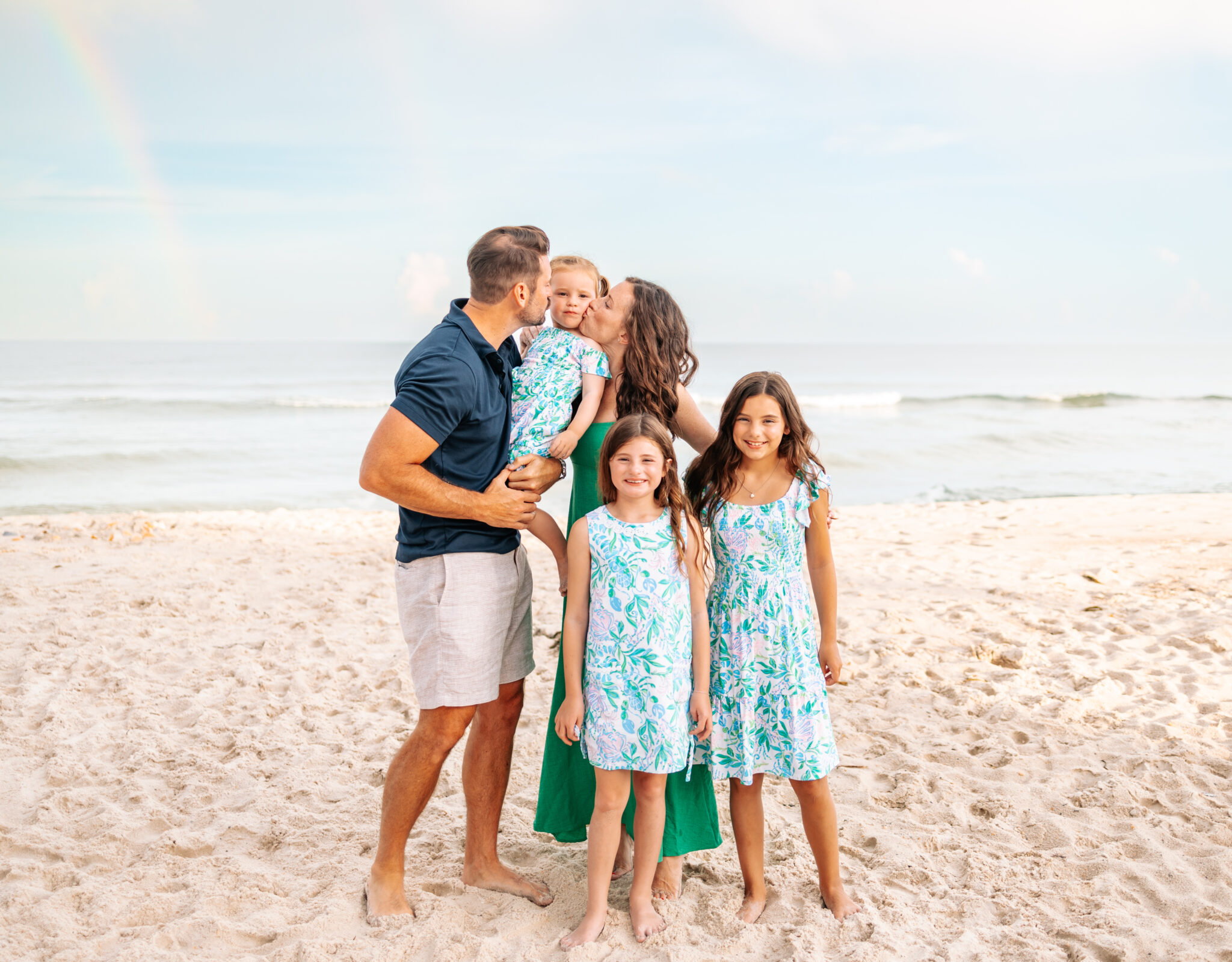 beach family photos in green and blue outfits